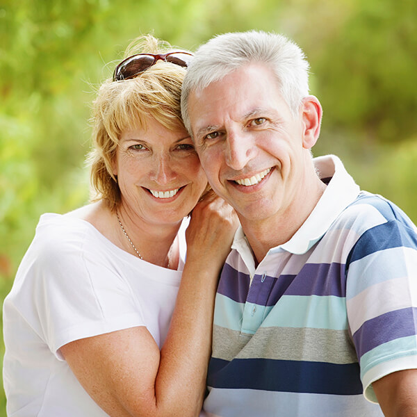 A couple smiling in the park