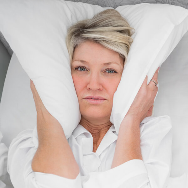 Woman suffering from sleep apnea